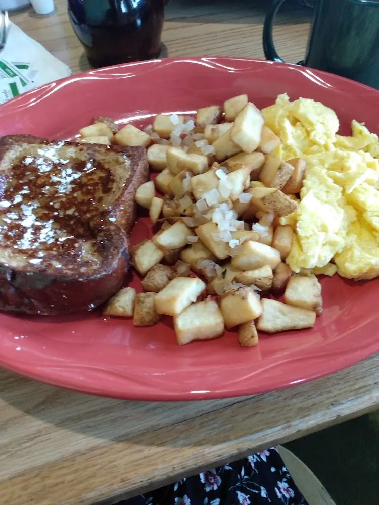One Pancake or One French Toast Fried Potatoes with Onion or Hash Browns and Two Eggs